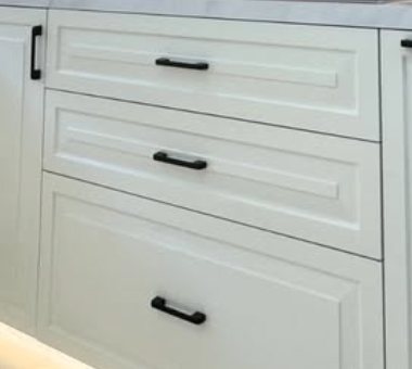 Matte black handles on shaker drawers