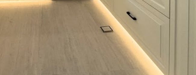Warm plinth lighting under kitchen cabinets