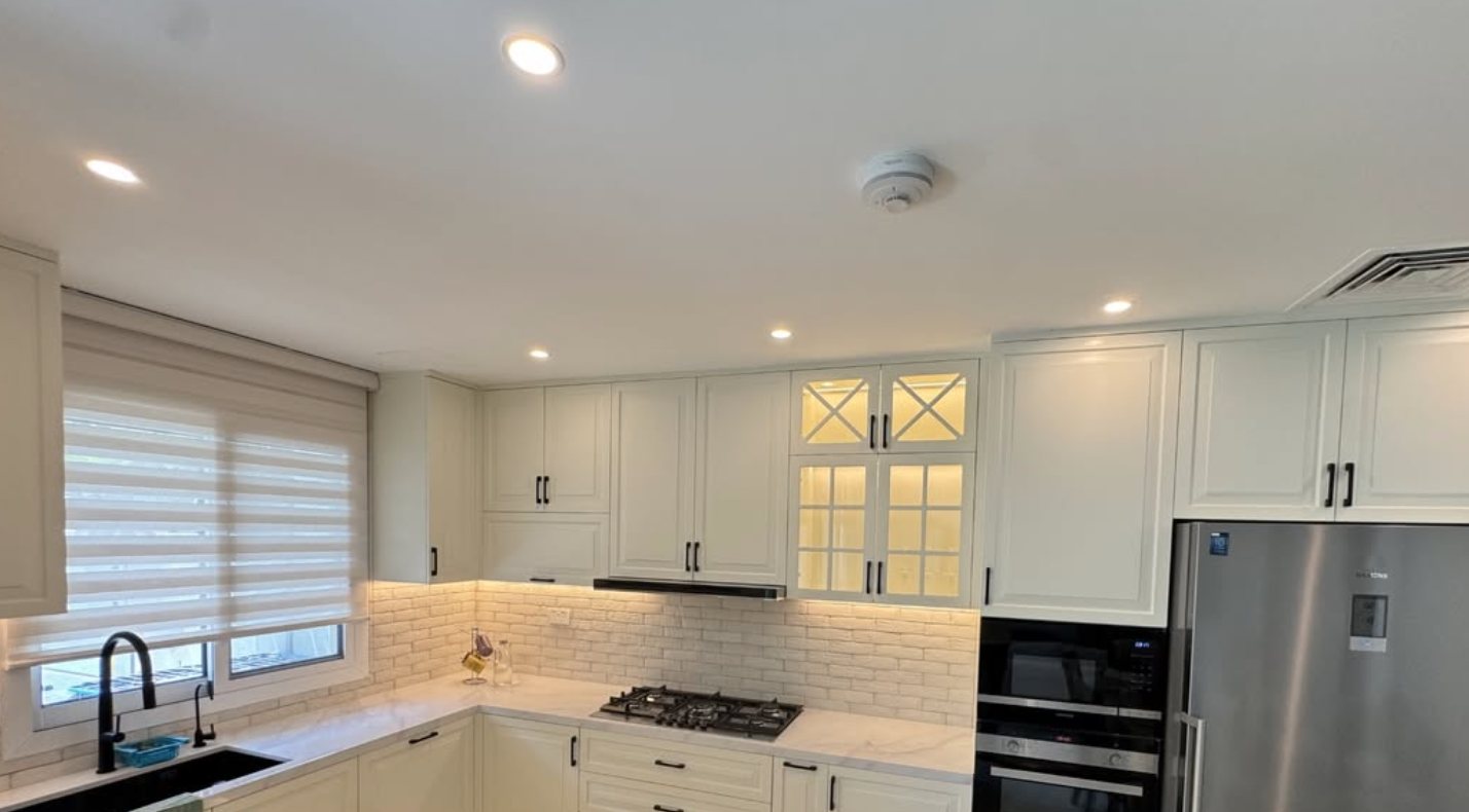 Finished white kitchen with integrated oven and stainless fridge